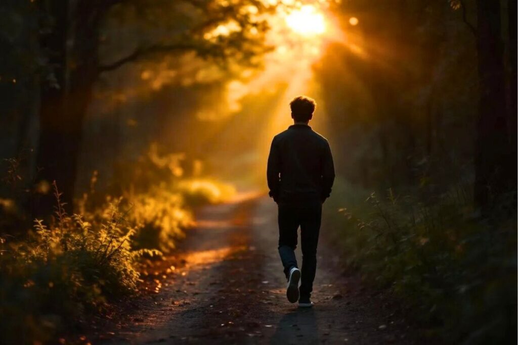 Young adult walking alone in a peaceful, area reflecting calmness and inner healing.