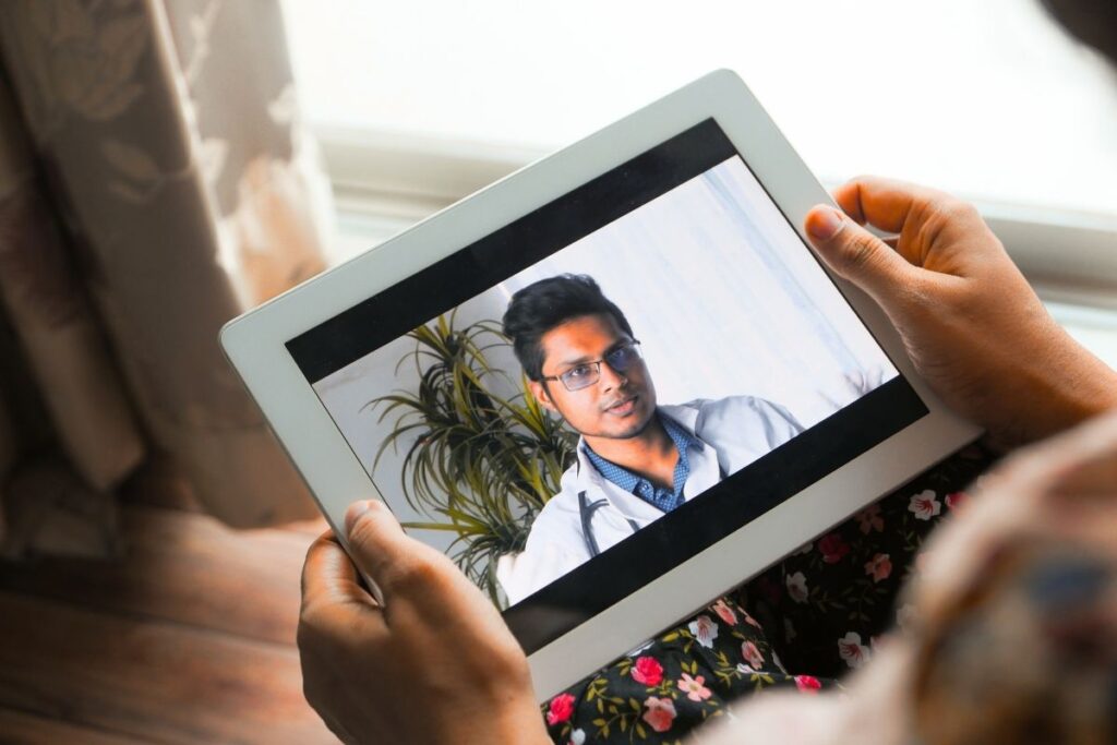 Doctor conducting online video counselling for an alcohol addict.
