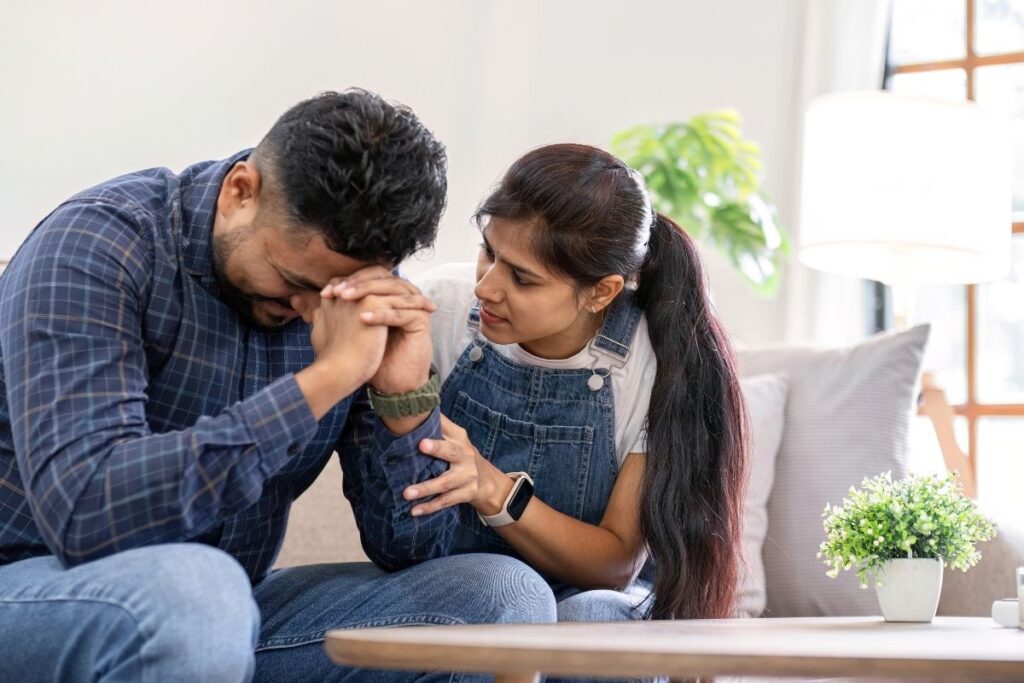  young woman offering emotional support to an adult during alcohol recovery.