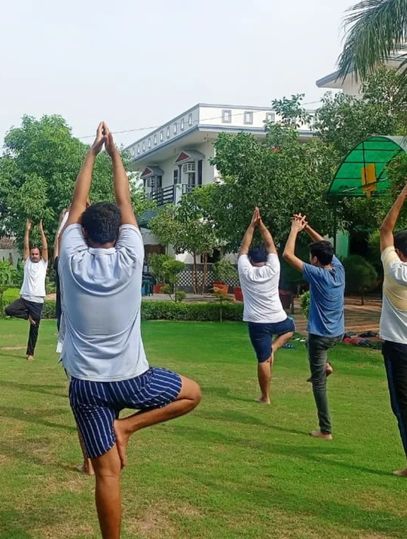 Young adults practicing yoga at rehab in India.