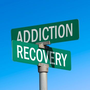 Board signs towards alcohol addiction recovery road