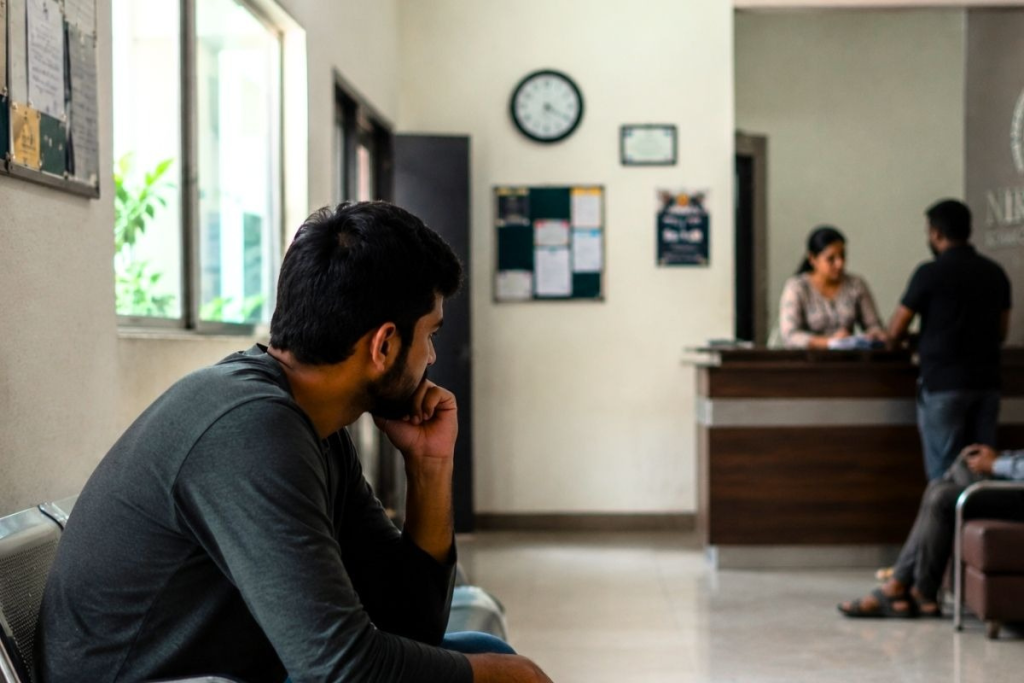 A person pondering how addiction treatment can help rebuild healthy lifestyles again
